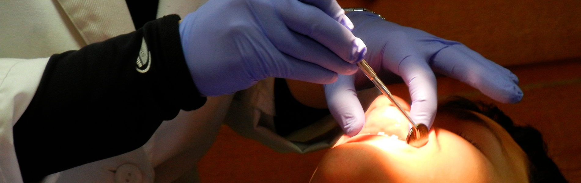 Imagem de dentista realizando procedimento em paciente