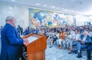 Foto do encontro de reitores e diretores das Instituições Públicas de ensino superior. Na imagem, o presidente Lula está com um terno de cor azul, em pé em um púlpito realizando o discurso. Na sua frente, a plateia está sentada e é composta por representantes de Universidades e Institutos Federais
